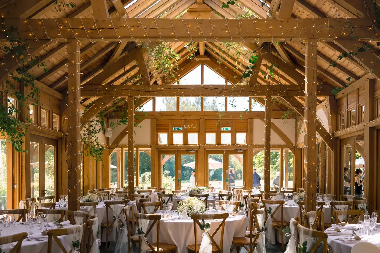 The Oak Tree of Peover wedding breakfast room, with warm timber beams and fairy lights