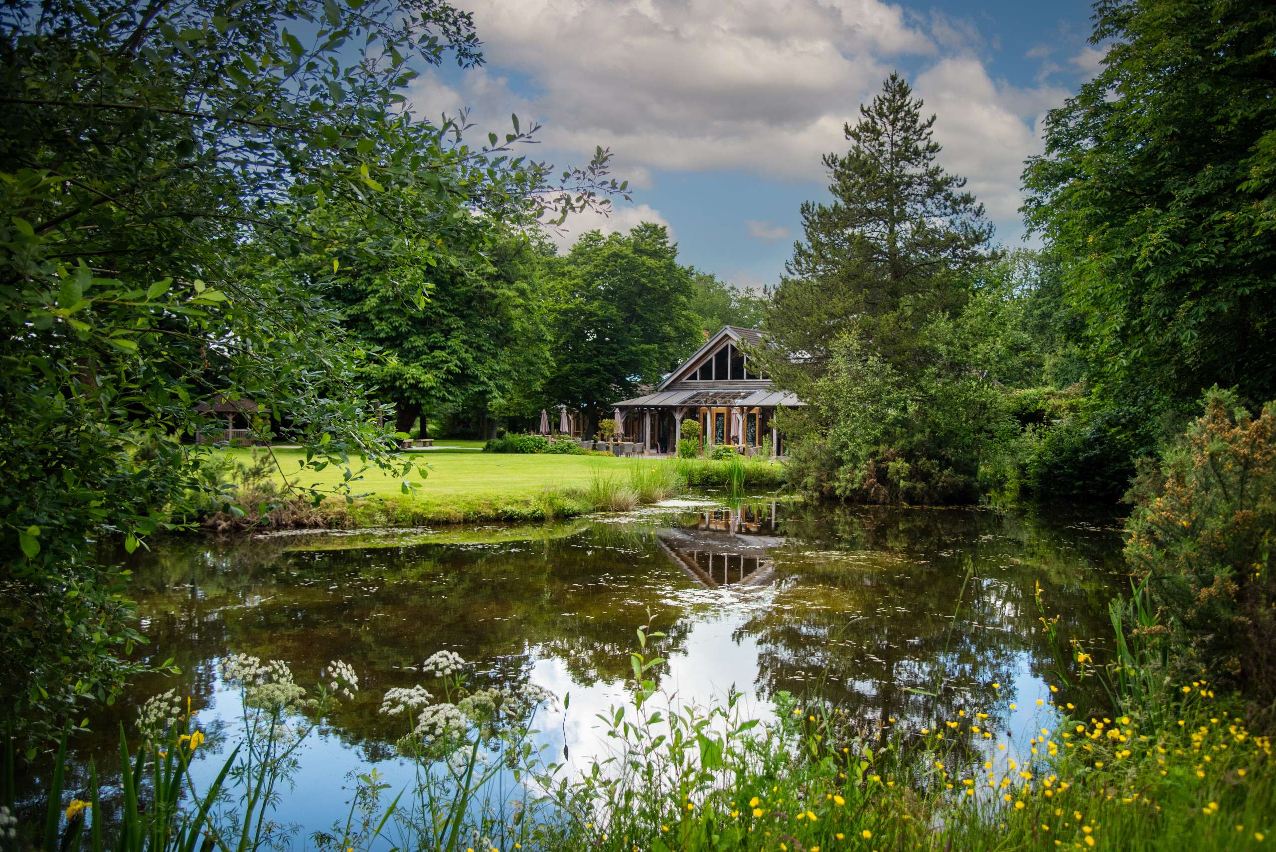 The Oak Tree of Peover surrounded by its gardens and pond